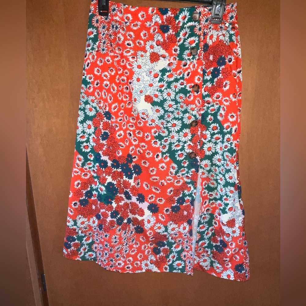 Women’s midi skirt. A orange/coral with teal, beige, and white accents.